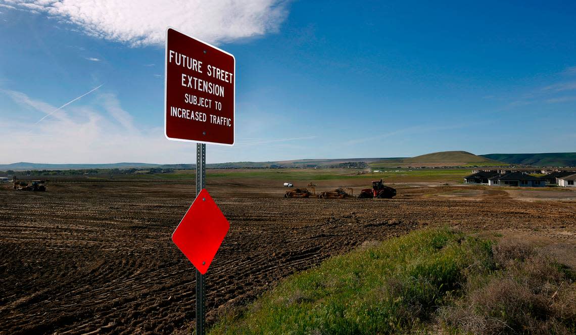 Earth moving equipment prepares the land for the lots and roads of a new housing development called South Orchard in the Badger Mountain South area of Richland.