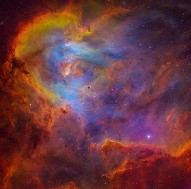 The Running Chicken Nebula, rich with color and speckled with stars.