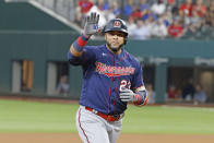 Minnesota Twins' Nelson Cruz (23) waves to family in the stands as he celebrates his two-run home run against the Texas Rangers during the fourth inning of a baseball game Saturday, June 19, 2021, in Arlington, Texas. (AP Photo/Michael Ainsworth)