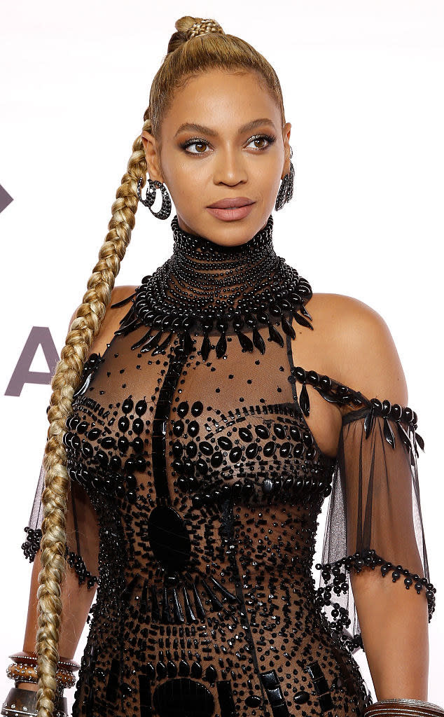 Beyonce posing in a sheer beaded dress