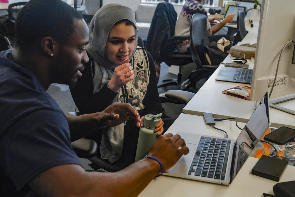 Calvin Milliner, left, and Reem Farhat, reporters for The News Movement (TNM), a social media news operation re-imagined for Gen-Z consumers, review video Thursday, March 2, 2023, in New York. TNM uses a staff of reporters with an average age of 25 to make tailored news content for sites like TikTok, Instagram, YouTube and Twitter. (AP Photo/Bebeto Matthews)