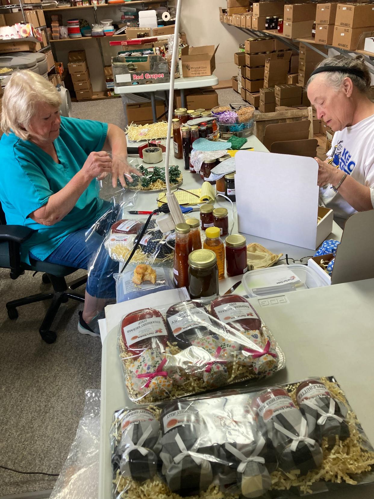 Char Barrie, left, and Kris Barrie decorate jellies to prepare for Arts in the Park this weekend in Aberdeen.