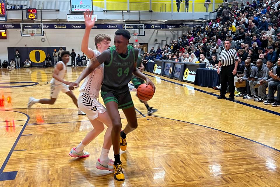 Xavier Booker (34) and Indianapolis Cathedral, took on Jeremy Fears Jr. (back, left) and Joliet West at the Bank of O'Fallon Shootout on Saturday night in O'Fallon, Illinois. Booker and Fears, both McDonald's All-Americans, are headed to Michigan State next season.