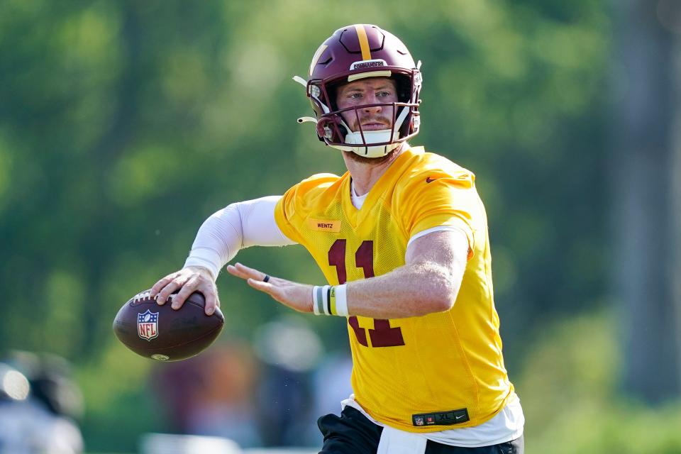 Washington Commanders quarterback Carson Wentz (11) looks to throw the ball during practice at the team's NFL football training facility, Wednesday, Aug. 10, 2022, in Ashburn, Va.