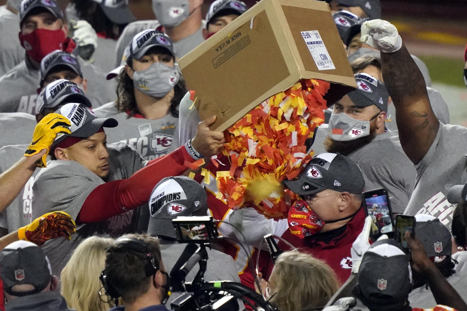 Kansas City Chiefs players dump a box of confetti on head coach Andy Reid after the AFC championship NFL football game against the Buffalo Bills, Sunday, Jan. 24, 2021, in Kansas City, Mo. The Chiefs won 38-24. (AP Photo/Jeff Roberson)