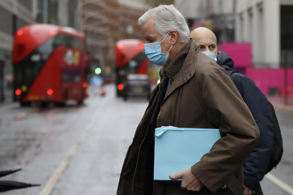 European Union chief Brexit negotiator Michel Barnier, foreground, walks to the Conference Centre in London, Thursday, Dec. 3, 2020. With less than one month to go before the U.K. exits the EU's economic orbit, talks are continuing, and U.K. officials have said this is the last week to strike a deal. (AP Photo/Kirsty Wigglesworth)