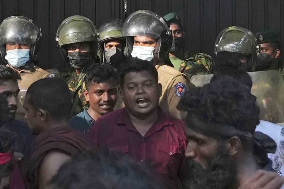 University student leader Wasantha Mudalige, center, participates in a protest in Colombo, Sri Lanka, Sunday, April 24, 2022. Amnesty International is urging the Sri Lankan government to drop the charges against two prominent protest leaders, including Mudalige, detained for more than three months over their role in recent ant-government demonstrations against the economic crisis that has engulfed the island nation for months. (AP Photo/Eranga Jayawardena, File)