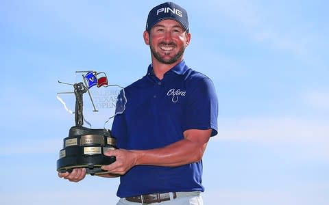 Andrew Landry poses with trophy - Credit: GETTY IMAGES