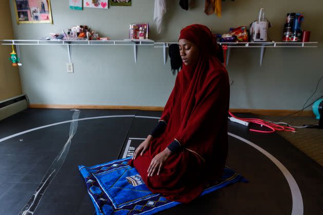 Ibrahim prays in her dorm room before wrestling practice, April 16. 