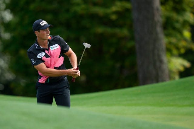 Viktor Hovland watches his putt on the eighth