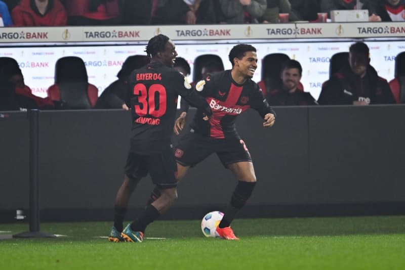 Leverkusen's Jeremie Frimpong (L) celebrates scoring his side's first goal with teammate Amine Adli during the German DFB Cup semi final soccer match between Bayer Leverkusen and Fortuna Duesseldorf at BayArena. Marius Becker/dpa