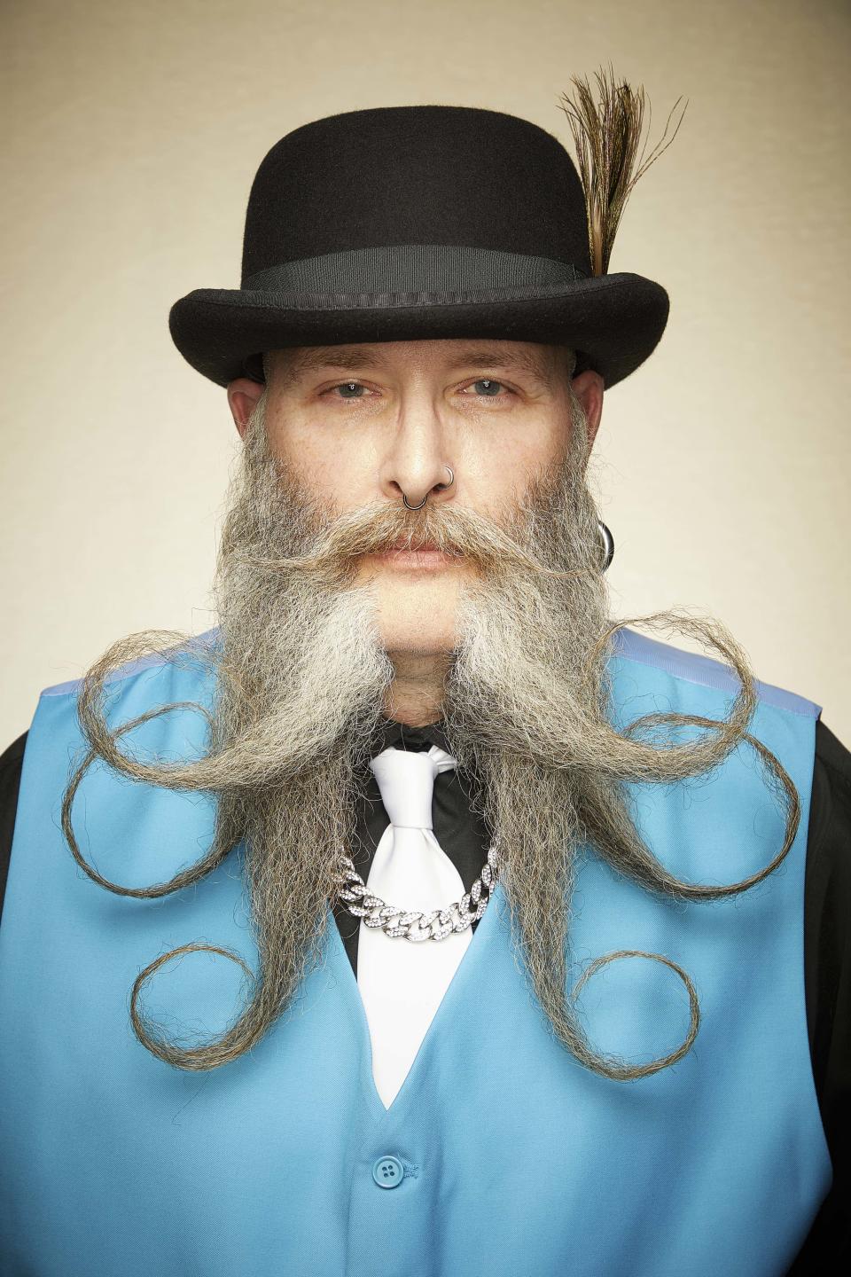 Against the gentleman's blue waistcoat, this facial hair resembles a squid. 
