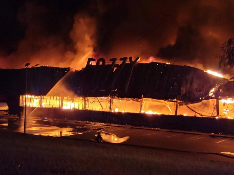 Firefighters work to put out a fire in a supermarket during a Russian drone and missile strike in Odesa.