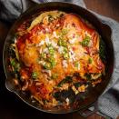 <p>Put out your favorite toppings for these quick and healthy layered enchiladas. We like cilantro, sour cream, guacamole and jalapeños.</p> <p> <a href="https://www.eatingwell.com/recipe/260921/adobo-chicken-kale-enchiladas/" rel="nofollow noopener" target="_blank" data-ylk="slk:View Recipe" class="link ">View Recipe</a></p>