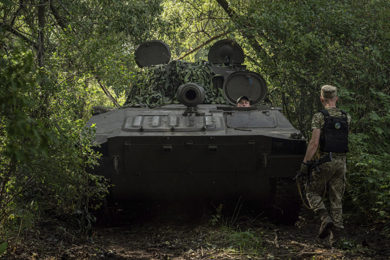 A Ukrainian self-propelled artillery drives to position to shoot towards Russian forces at a frontline in Kharkiv region, Ukraine, Wednesday, July 27, 2022. (AP Photo/Evgeniy Maloletka)