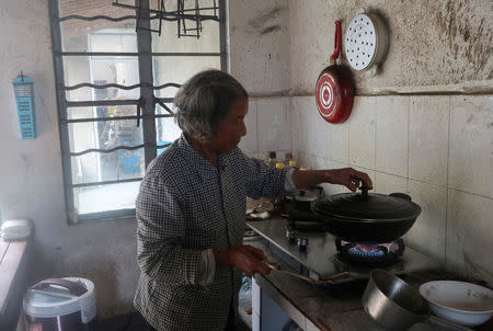 Local resident Fei Jinxian prepares food in her kitchen in Fengxian, a rural suburb of Shanghai, China October 25, 2017. REUTERS/David Stanway