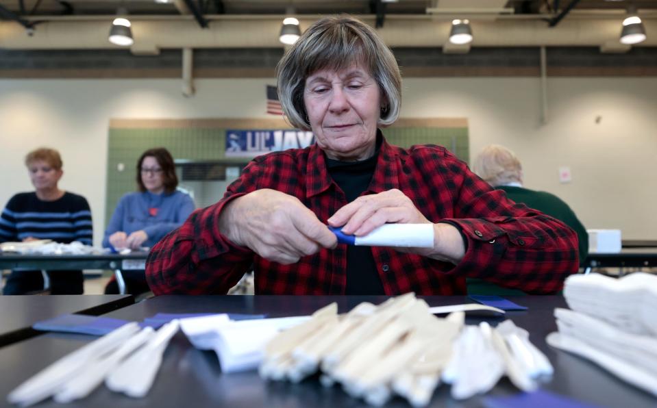 Kathy Shepard, of Mt Pleasant, rolls up more silverware inside the cafeteria at Shepherd Elementary School in Shepherd on Saturday, April 22, 2023 for next weekends Shepherd Maple Syrup Festival.
The festival which raises money for the town will go through 1,450 gallons of maple syrup, 7,000 pounds of sausage and 2,600 pounds of pancake mix during the three day event.