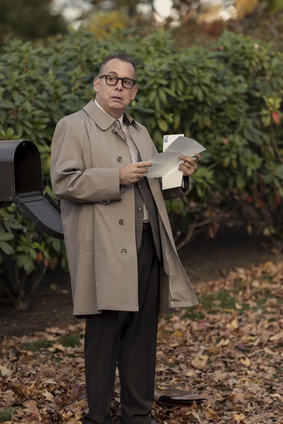 Joe Mantello as Graff in "The Watcher" opening a letter while standing outside