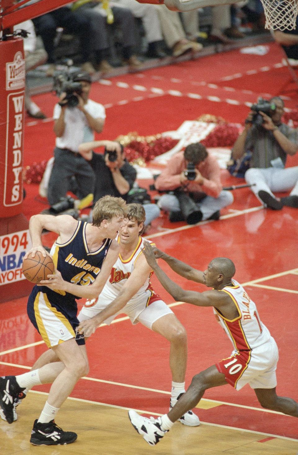 Indiana Pacers Rik Smits (45) is double-teamed by Atlanta Hawks Jon Koncak (32) and Mookie Blaylock (10) as he drives under the basket during the first half of the Eastern Conference semifinals at The Omni, Thursday, May 12, 1994, Atlanta, Ga.