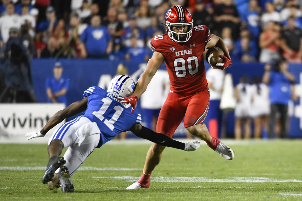 Utah tight end Brant Kuithe (80) jukes around Brigham Young defensive back Isaiah Herron (11) during the first half of an NCAA college football game Saturday, Sept. 11, 2021, in Provo, Utah. (AP Photo/Alex Goodlett)