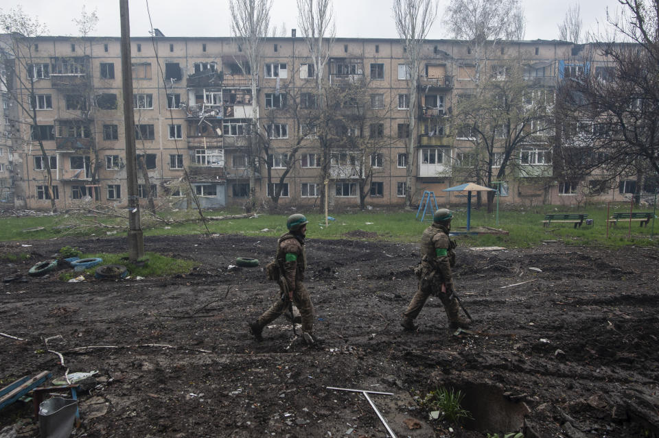 FILE - Ukrainian soldiers walk in an area of the heaviest battles in Bakhmut, Donetsk region, Ukraine, Friday, April 21, 2023. Ukrainian President Volodymyr Zelenskyy said Sunday, May 21, 2023 that Russian forces weren't occupying Bakhmut, casting doubt on Moscow's insistence that the eastern Ukrainian city had fallen. The fog of war made it impossible to confirm the situation on the ground in the invasion’s longest battle, and the comments from Ukrainian and Russian officials added confusion to the matter. (Iryna Rybakova via AP, File)