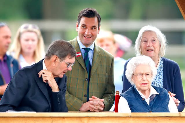 <p>Max Mumby/Indigo/Getty</p> Queen Elizabeth attends the Royal Windsor Horse Show with Lieutenant Colonel Tom White (2nd L) in July 2021.