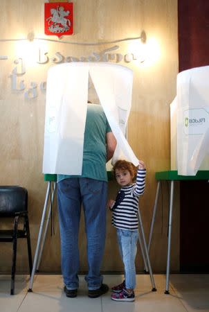 People vote during the parliamentary election in Tbilisi, Georgia, October 8, 2016. REUTERS/David Mdzinarishvili