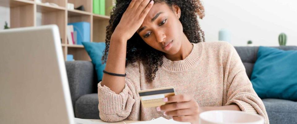 Woman with problem using credit card for online shopping