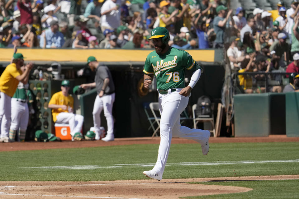 Oakland Athletics' Dermis Garcia (76) scores a run on a double by Shea Langeliers against the New York Mets during the first inning of a baseball game in Oakland, Calif., Saturday, Sept. 24, 2022. (AP Photo/Tony Avelar)