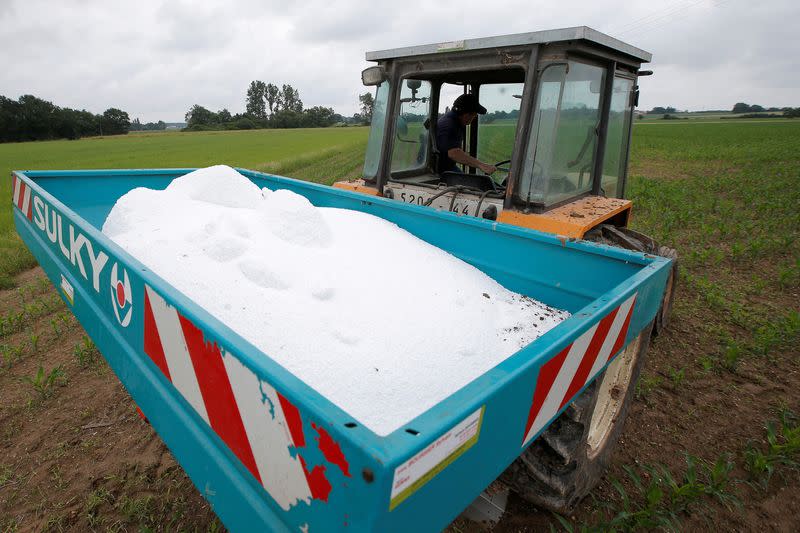 FILE PHOTO: A farmer prepares to use urea fertilizer in his cornfield in La Planche near Nantes