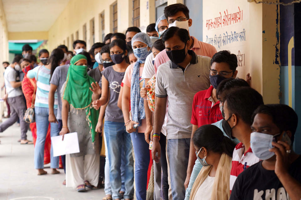 People stand in a queue to receive a dose of COVID-19 Vaccine, as vaccination for the age 18 to 44 age group starts, in Ajmer, Rajasthan, India. Source: PA