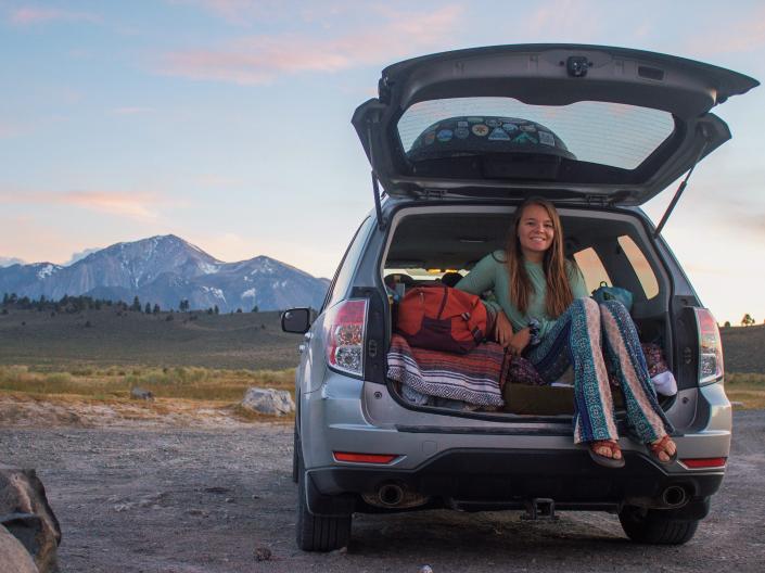 nicole sitting int he trunk of her subaru forester