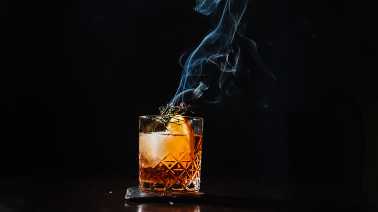 Smoked old fashioned on black background