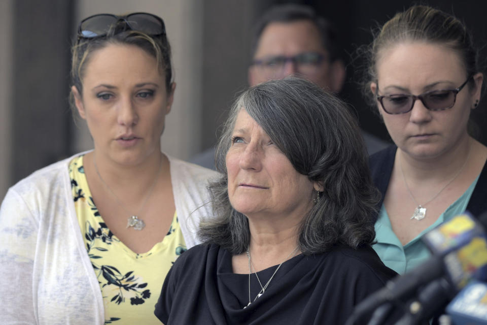 Surrounded by family and friends, Debra Sorrells, the mother of Baltimore County Police Officer Amy Caprio, gazes skyward following the life sentence for her daughter's death, meted out for 17-year-old Dawnta Harris at Baltimore County Circuit Court Wednesday, Aug. 21, 2019, in Towson, Md. Harris was tried as an adult earlier this year and convicted of felony murder in the slaying of Officer Caprio. (Karl Merton Ferron/The Baltimore Sun via AP)