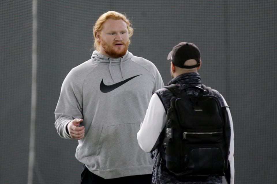 North Dakota State offensive tackle Cody Mauch, left, talks with a scout during NFL football Pro Day at North Dakota State University, March 29, 2023, in Fargo, N.D. The Tampa Bay Buccaneers moved to strengthen a weak offensive line, selecting Mauch in the second round of the NFL draft Friday, April 28, 2023. (AP Photo/Andy Clayton-King, File)