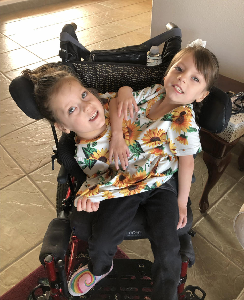 Callie and Carter, who get around in a wheelchair, are learning to walk in physical therapy.   (Courtesy Chelsea Torres)