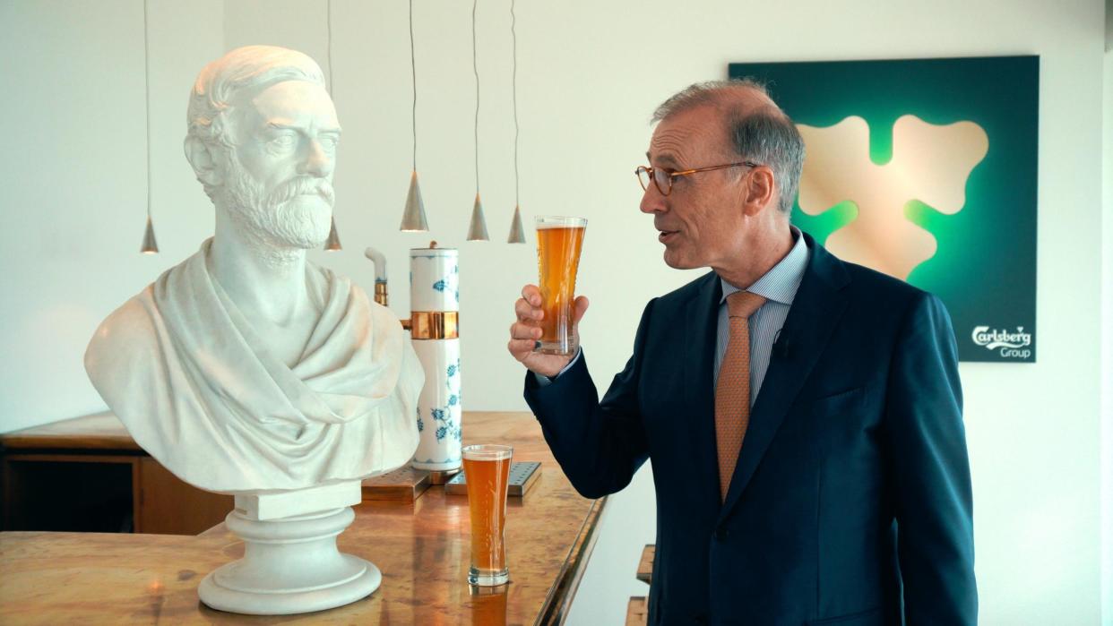 Cheers: Carlsberg boss Cees ‘t Hart, pictured with a bust of founder JC Jacobsen