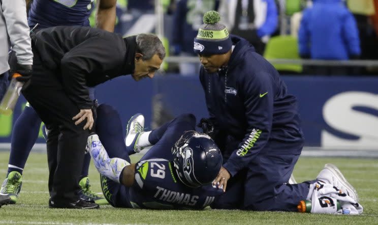 Seattle safety Earl Thomas paid a heavy price on rough landing during a pass breakup against Carolina. (AP) 