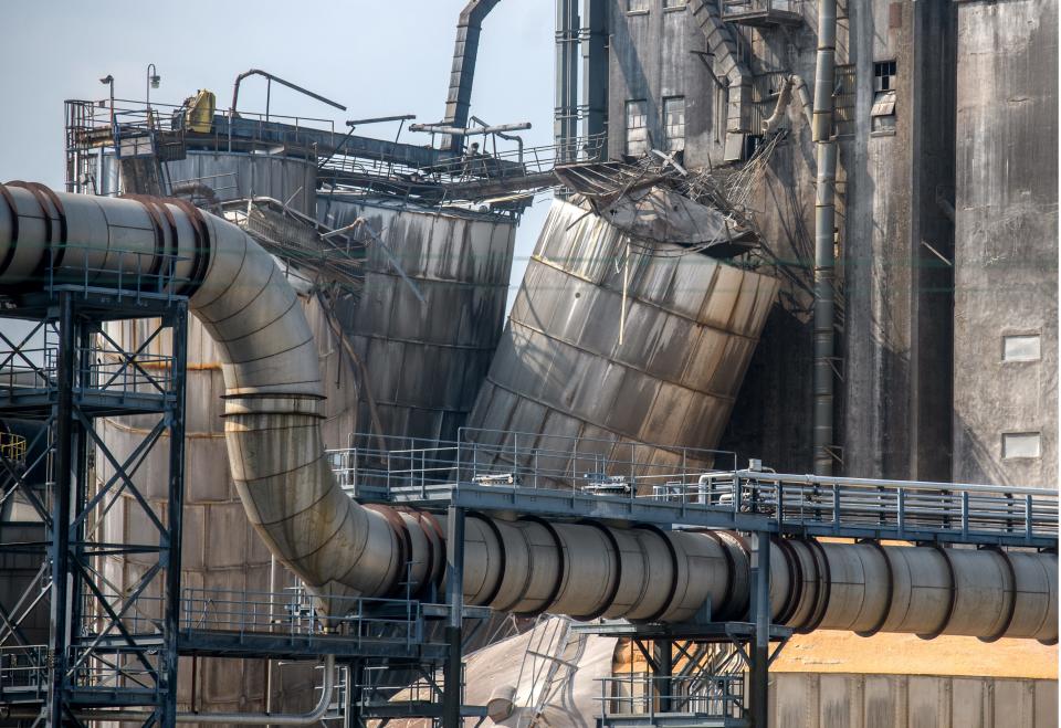 Damaged grain silos lean over after an explosion Wednesday night at the BioUrja ethanol plant on Southwest Washington Street in Peoria.