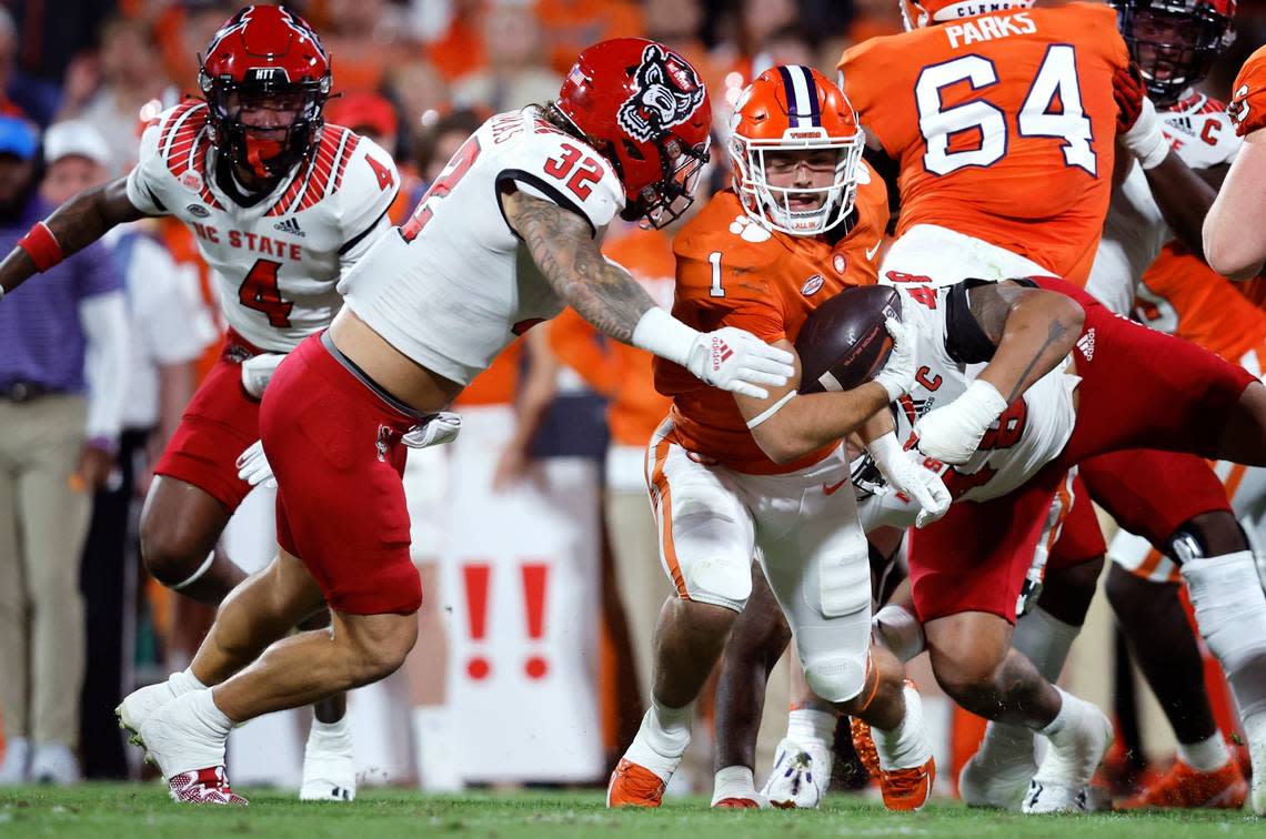 N.C. State linebacker Drake Thomas (32) closes in on Clemson running back Will Shipley (1) during the first half of N.C. State’s game against Clemson at Memorial Stadium in Clemson, S.C., Saturday, Oct. 1, 2022.