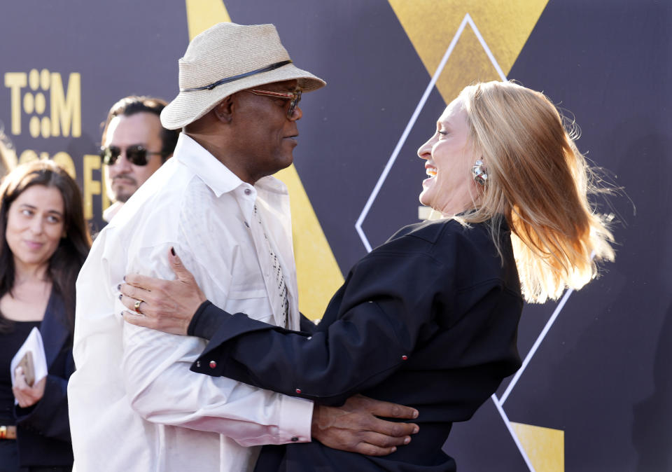 Samuel L. Jackson, left, and Uma Thurman, cast members in "Pulp Fiction," greet each other at a 30th anniversary screening of the film on the opening night of the 2024 TCM Classic Film Festival, Thursday, April 18, 2024, at the TCL Chinese Theatre in Los Angeles. (AP Photo/Chris Pizzello)