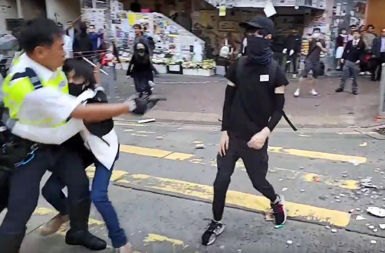 A video grab shows the moment a police officer shoots a black-clad pro-democracy protester in the abdomen during a protest in Sai Wan Ho district, in Hong Kong, on Monday morning: Cupid News/AFP
