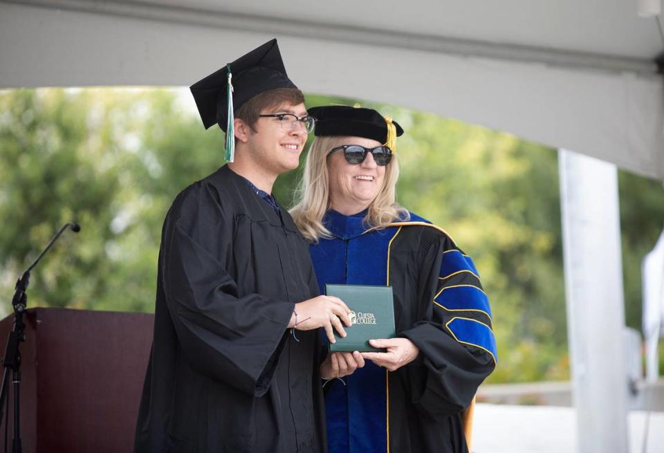 Cuesta College held its 59th commencement ceremony at the San Luis Obispo campus on Friday, May 17, 2024. Grant Boggs, a psychology graduate, poses for a photo next to Cuesta College superintendent Jill Stearns.