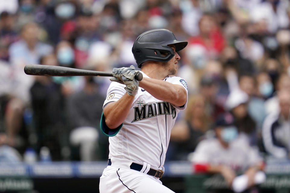 Seattle Mariners' Kyle Seager watches the path of his two-run double against the Boston Red Sox in the third inning of a baseball game Wednesday, Sept. 15, 2021, in Seattle. (AP Photo/Elaine Thompson)