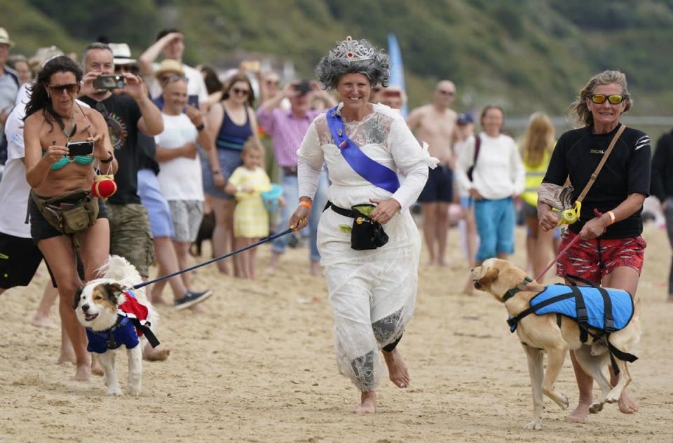 Ms Wilkinson races to the finish line with her dog Diogie (Andrew Matthews/PA) (PA Wire)