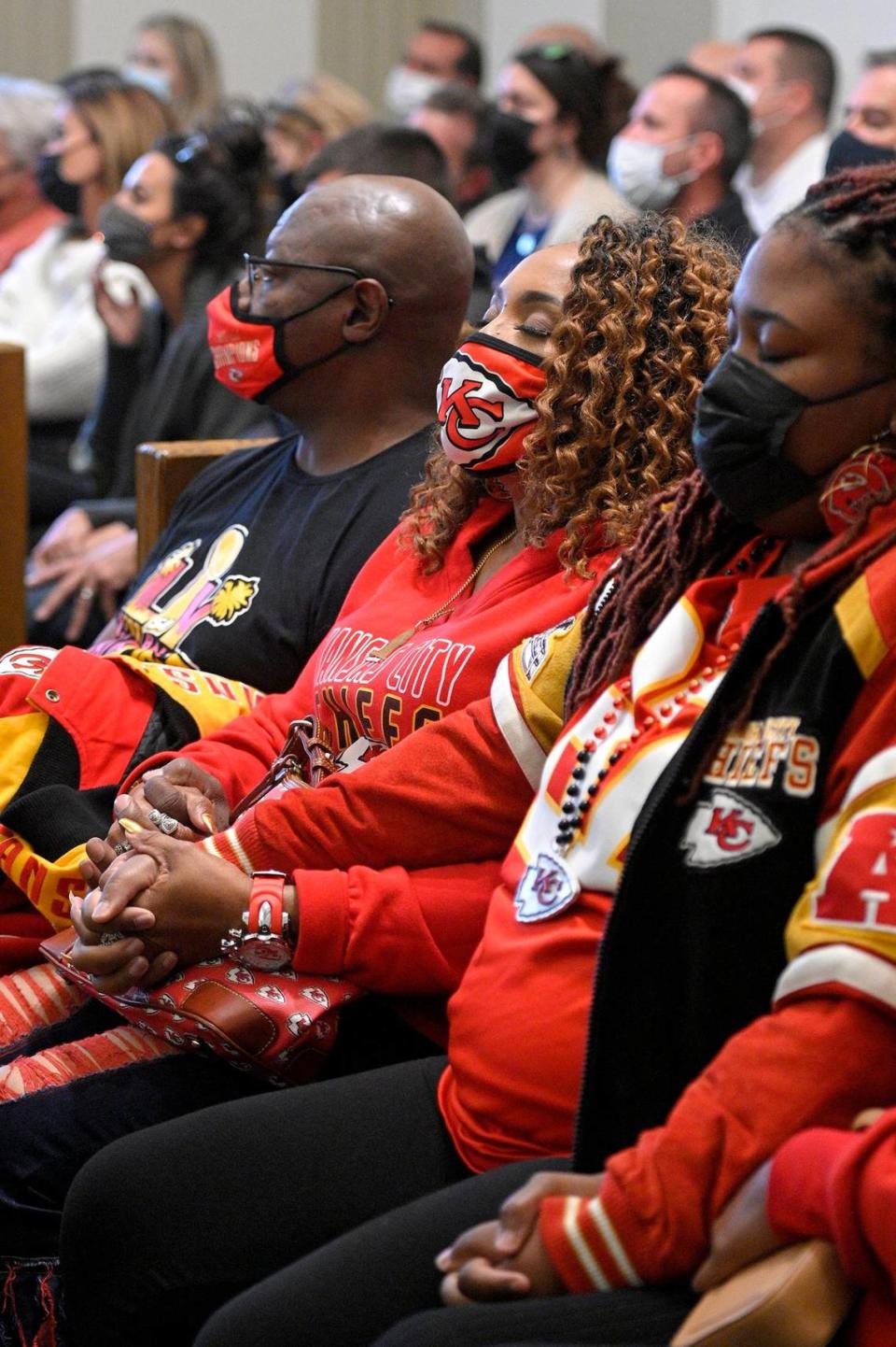 Cameron Lamb’s stepfather Aqil Bey, from left, mother Laurie Bey and supporters hold hands as they wait to hear the verdict. Jackson County Circuit Court Judge J. Dale Youngs announced on Friday, November 19, 2021, that he found Eric DeValkenaere, a Kansas City police detective, guilty in the fatal December 2019 shooting of Cameron Lamb. 