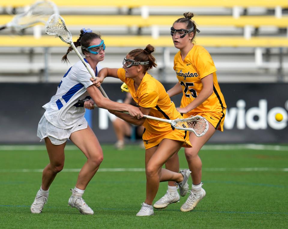 Upper Arlington's Lilly Boyle, center, and Alex Burns (25) defend Olentangy Liberty's Isabelle Pohmer during the 2023 Division I state final.