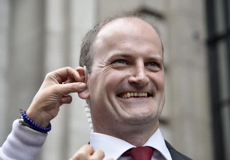 Member of Parliament (MP) Douglas Carswell has an earpiece fitted before a television interview in central London August 28, 2014. REUTERS/Toby Melville