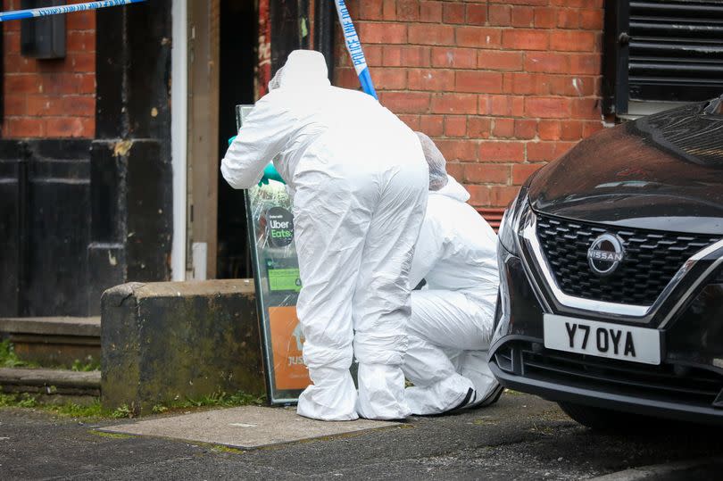 Forensic officers on the scene in Oldham