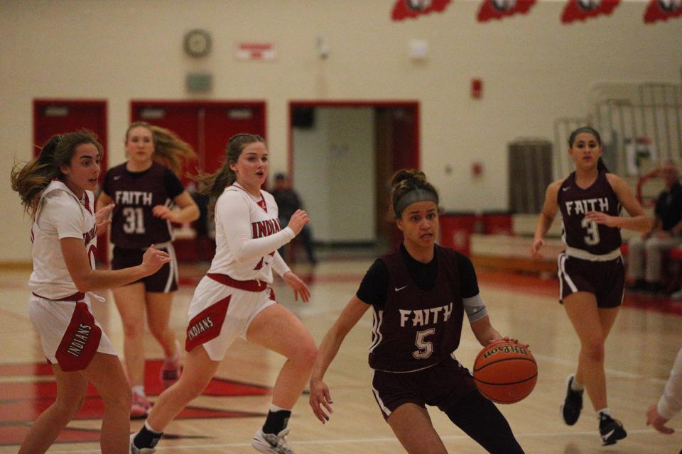 Faith Christian sophomore Maya Layton (center) attempts to sidestep Twin Lakes senior Olivia Nickerson and sophomore Taylor Oliver (back) during the Twin Lakes Holiday Tournament on Wednesday, Dec. 27, 2023.